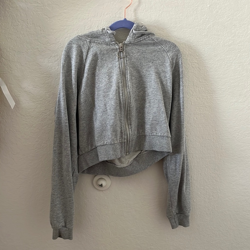 Selling a size Large cropped light gray zip up hoodie from Tilly’s